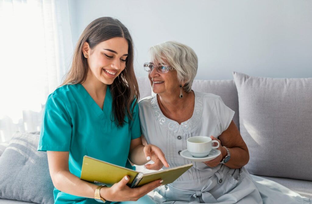 A senior talking and smiling with a caregiver at a senior living community