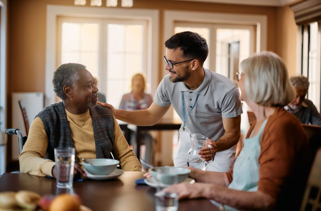 Two seniors enjoying a meal together in a memory care facility dining room in Delaware.