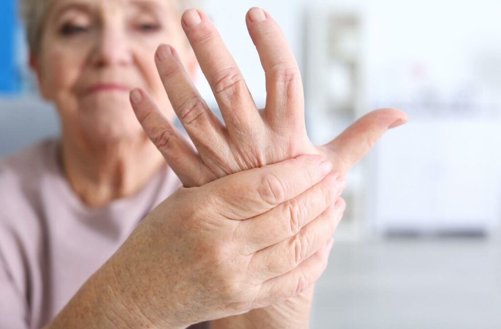 Elderly woman suffering from pain in hand, closeup