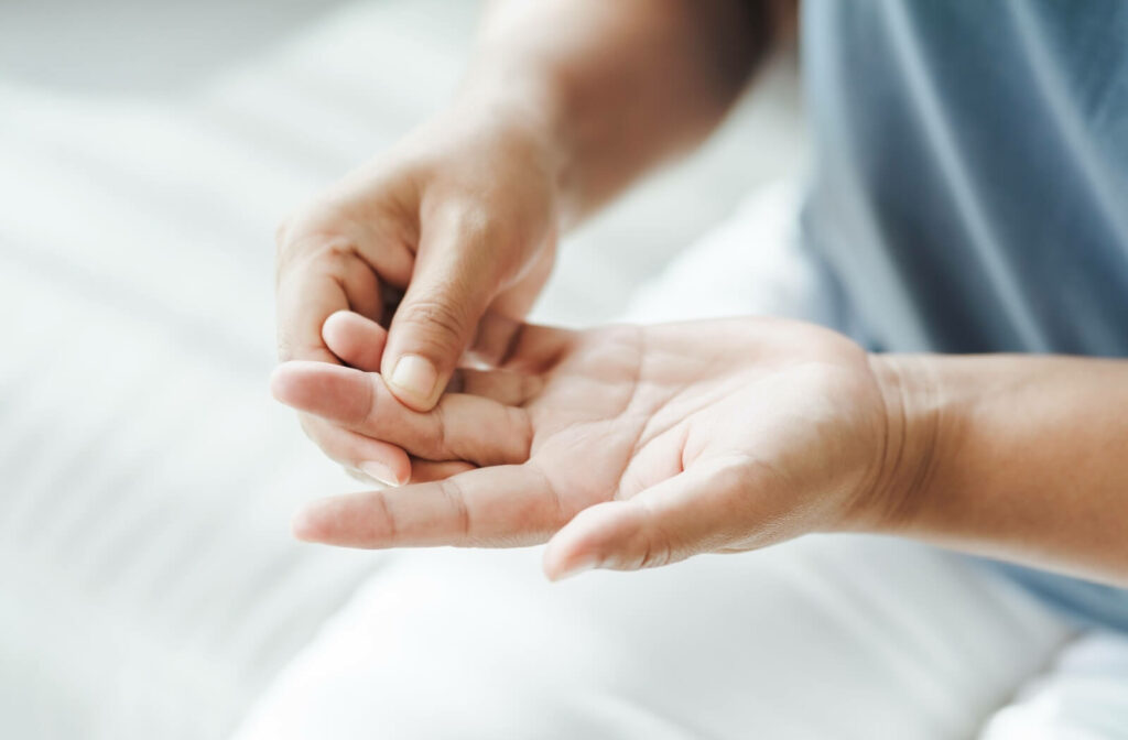 Woman suffering from hand and finger joint pain.