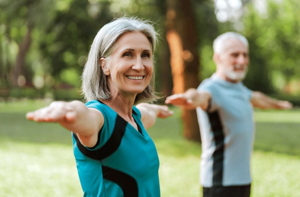 two older adult doing a standing exercise