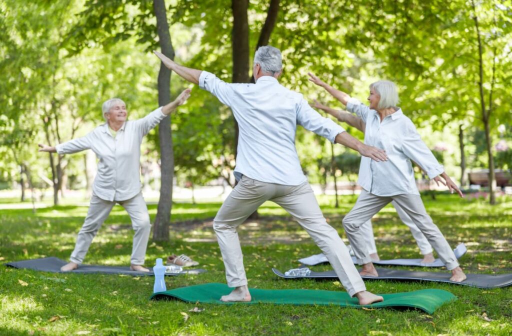 three older adults doing some standing exercises