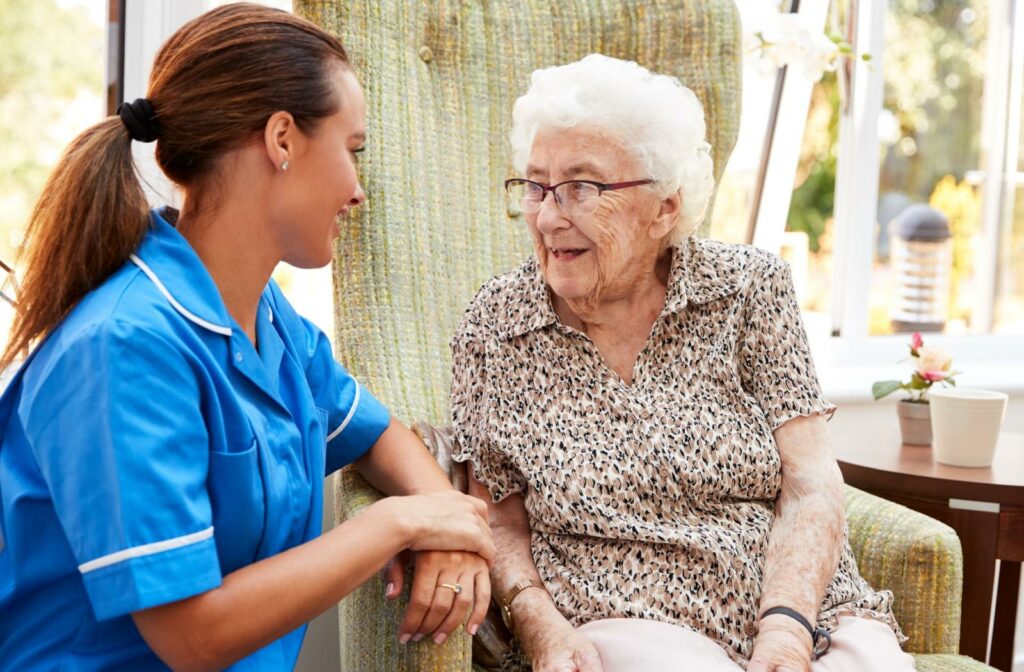 a caregiver has a conversation with a senior memory care resident.